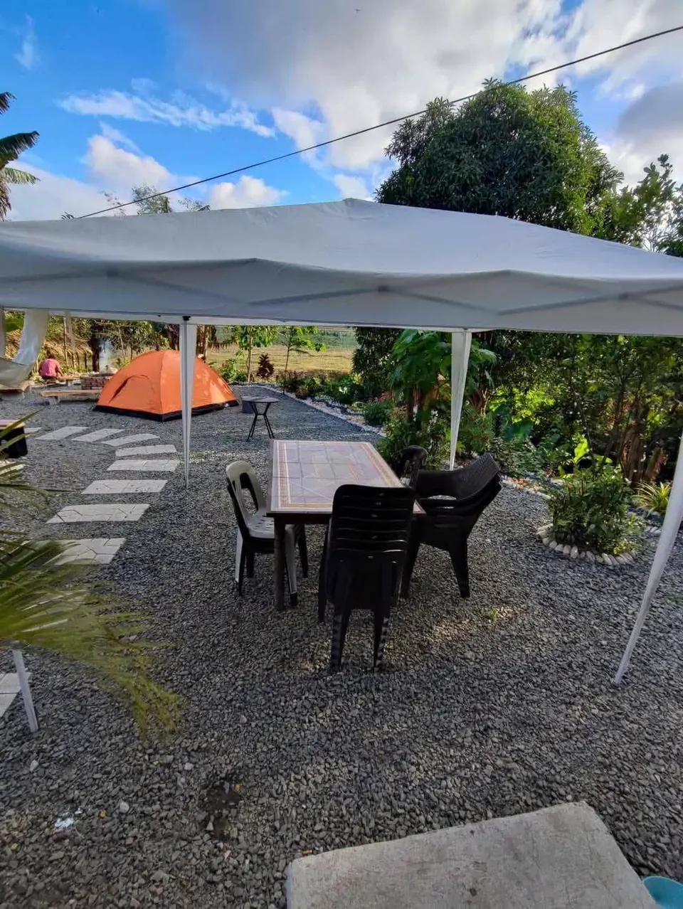 Shaded tent-pitching area with canopy and seating