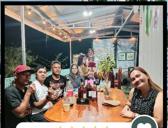 Guests around the gazebo dining table in the evening
